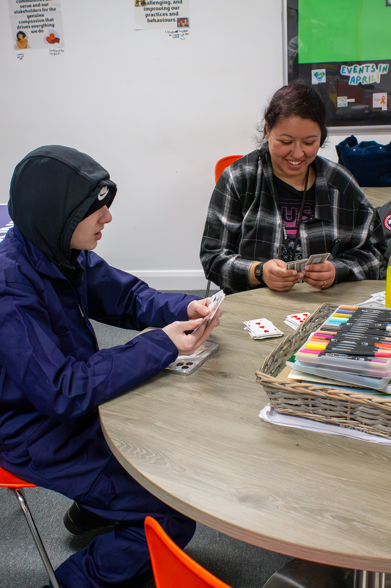 BJC student playing cards with teacher